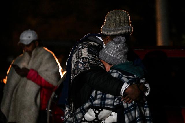 Relatives mourn the death of nine miners after an explosion at a coal mine in Sutatausa, Cundinamarca department, Colombia on May 4, 2026. Nine miners died and six others were rescued following an explosion at a legal coal mine in central Colombia on May 4, 2026, according to the final tally released by authorities at the end of the search operation. (Photo by Luis ACOSTA / AFP)