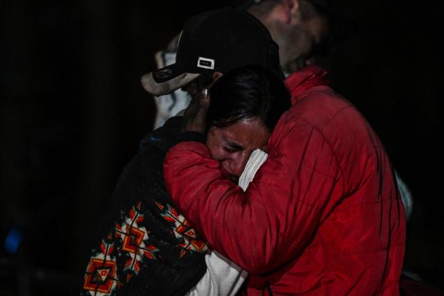Relatives mourn the death of nine miners after an explosion at a coal mine in Sutatausa, Cundinamarca department, Colombia on May 4, 2026. Nine miners died and six others were rescued following an explosion at a legal coal mine in central Colombia on May 4, 2026, according to the final tally released by authorities at the end of the search operation. (Photo by Luis ACOSTA / AFP)