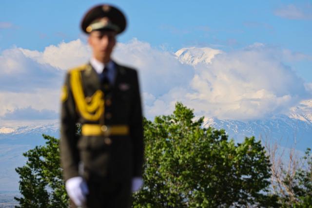 An Armenian honour guard waits for the arrival of French President at the Tsitsernakaberd Armenian Genocide Memorial, with Mount Ararat seen in distance, in Yerevan on May 5, 2026. (Photo by Ludovic MARIN / AFP)