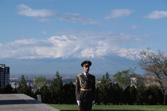 An Armenian honour guard waits for the arrival of French President at the Tsitsernakaberd Armenian Genocide Memorial, with Mount Ararat seen in distance, in Yerevan on May 5, 2026. (Photo by Ludovic MARIN / AFP)