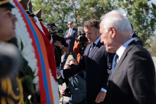 France's President Emmanuel Macron attends a ceremony to lay wreaths at the Tsitsernakaberd Armenian Genocide Memorial in Yerevan on May 5, 2026. (Photo by Ludovic MARIN / AFP)