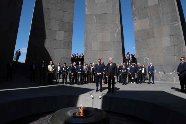 France's President Emmanuel Macron, Armenia's President Vahagn Khachaturyan and officials lay flowers at the Tsitsernakaberd Armenian Genocide Memorial in Yerevan on May 5, 2026. (Photo by Ludovic MARIN / AFP)