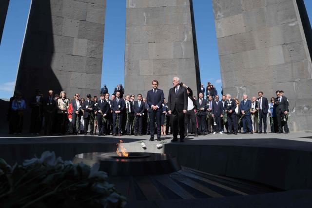 France's President Emmanuel Macron, Armenia's President Vahagn Khachaturyan and officials lay flowers at the Tsitsernakaberd Armenian Genocide Memorial in Yerevan on May 5, 2026. (Photo by Ludovic MARIN / AFP)