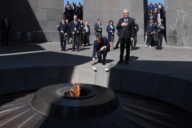 France's President Emmanuel Macron, Armenia's President Vahagn Khachaturyan and officials lay flowers at the Tsitsernakaberd Armenian Genocide Memorial in Yerevan on May 5, 2026. (Photo by Ludovic MARIN / AFP)