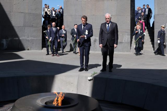France's President Emmanuel Macron, Armenia's President Vahagn Khachaturyan and officials lay flowers at the Tsitsernakaberd Armenian Genocide Memorial in Yerevan on May 5, 2026. (Photo by Ludovic MARIN / AFP)