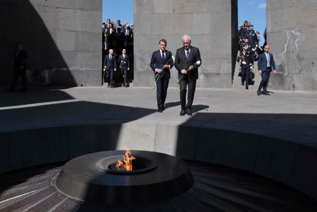 France's President Emmanuel Macron, Armenia's President Vahagn Khachaturyan and officials lay flowers at the Tsitsernakaberd Armenian Genocide Memorial in Yerevan on May 5, 2026. (Photo by Ludovic MARIN / AFP)