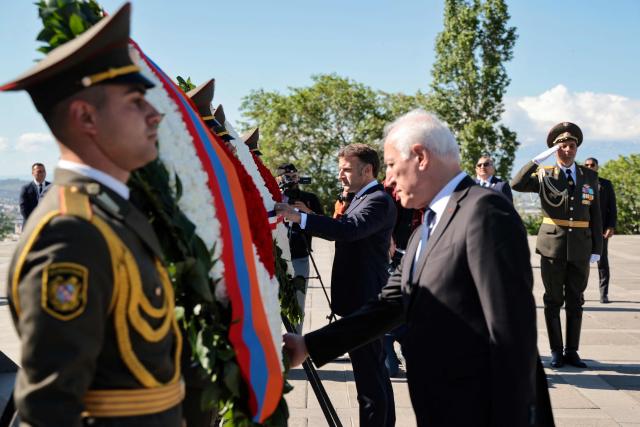 France's President Emmanuel Macron and Armenia's President Vahagn Khachaturyan attend a ceremony to lay wreaths at the Tsitsernakaberd Armenian Genocide Memorial in Yerevan on May 5, 2026. (Photo by Ludovic MARIN / AFP)
