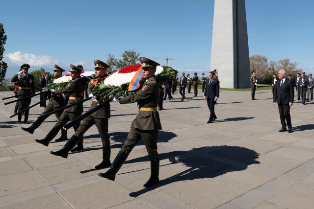 France's President Emmanuel Macron, Armenia's President Vahagn Khachaturyan and officials attend a ceremony to lay wreaths at the Tsitsernakaberd Armenian Genocide Memorial in Yerevan on May 5, 2026. (Photo by Ludovic MARIN / AFP)