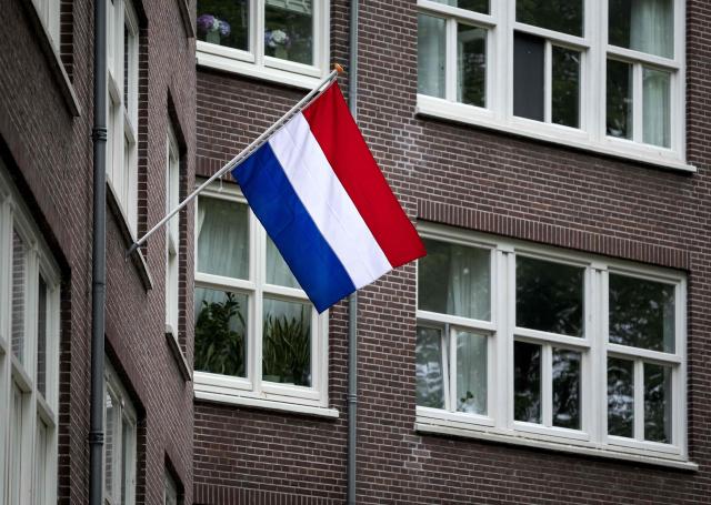 This photograph shows a Netherland's national flag displayed on Liberation Day in Amsterdam on May 5, 2026. The lighting of the Liberation Fire symbolizes the transition from commemorating the WWII to celebrating the Netherlands’ liberation from the German occupier. (Photo by Ramon van Flymen / ANP / AFP) / Netherlands OUT