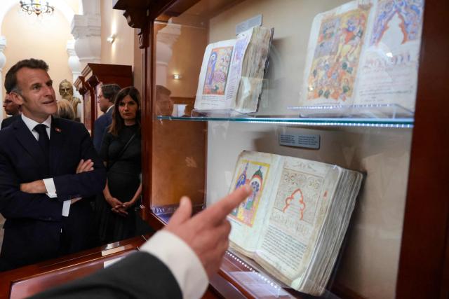 France's President Emmanuel Macron visits the Matenadaran museum, Armenia's cultural institution which houses the vast collection of ancient manuscripts, in Yerevan on May 5, 2026. (Photo by Ludovic MARIN / AFP)