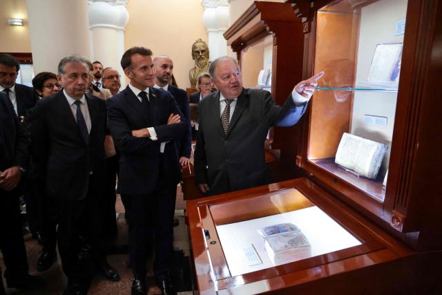 France's President Emmanuel Macron visits the Matenadaran museum, Armenia's cultural institution which houses the vast collection of ancient manuscripts, in Yerevan on May 5, 2026. (Photo by Ludovic MARIN / AFP)