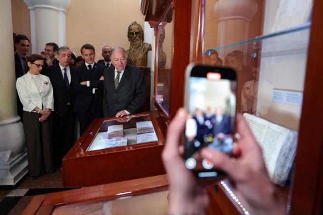 France's President Emmanuel Macron visits the Matenadaran museum, Armenia's cultural institution which houses the vast collection of ancient manuscripts, in Yerevan on May 5, 2026. (Photo by Ludovic MARIN / AFP)