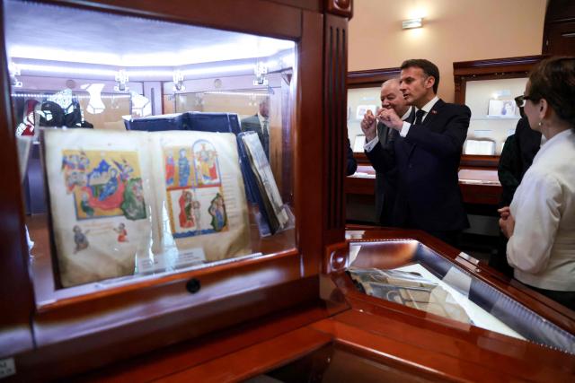 France's President Emmanuel Macron visits the Matenadaran museum, Armenia's cultural institution which houses the vast collection of ancient manuscripts, in Yerevan on May 5, 2026. (Photo by Ludovic MARIN / AFP)