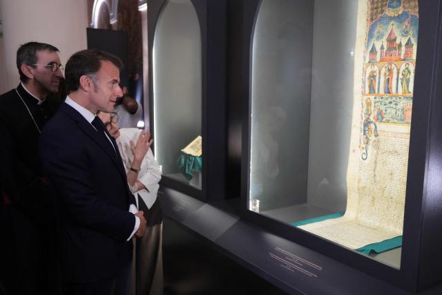 France's President Emmanuel Macron visits the Matenadaran museum, Armenia's cultural institution which houses the vast collection of ancient manuscripts, in Yerevan on May 5, 2026. (Photo by Ludovic MARIN / AFP)