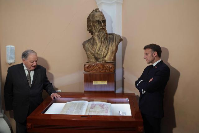 France's President Emmanuel Macron visits the Matenadaran museum, Armenia's cultural institution which houses the vast collection of ancient manuscripts, in Yerevan on May 5, 2026. (Photo by Ludovic MARIN / AFP)