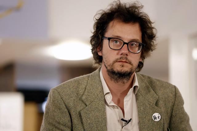 Reporters Without Borders (RSF) General Director Thibaut Bruttin listens during a press conference of the mother and stepfather of jailed French sports journalist Christophe Gleizes, in Paris on May 5, 2026. Gleizes was arrested in May 2024 and sentenced to seven years in prison in Algeria while travelling to northeastern Algeria's Kabylia region to write about the country's most decorated football club, Jeunesse Sportive de Kabylie. (Photo by Kenzo TRIBOUILLARD / AFP)