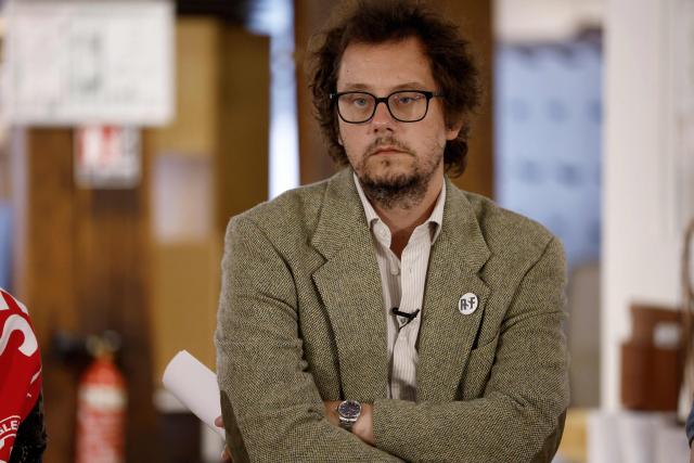 Reporters Without Borders (RSF) General Director Thibaut Bruttin listens during a press conference of the mother and stepfather of jailed French sports journalist Christophe Gleizes, in Paris on May 5, 2026. Gleizes was arrested in May 2024 and sentenced to seven years in prison in Algeria while travelling to northeastern Algeria's Kabylia region to write about the country's most decorated football club, Jeunesse Sportive de Kabylie. (Photo by Kenzo TRIBOUILLARD / AFP)