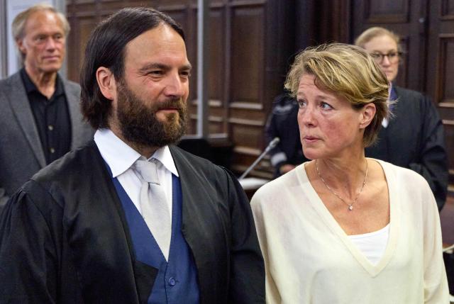 Co-defendant German former sports journalist Gerhard Delling (back L) stands behind his partner, defendant German entrepreneur and gastronome Christina Block (front R), who looks at her lawyer Ingo Bott (front L), while her lawyer Paula Wlodarek (back R) is seen in the background, as they wait for the continuation of Christina Block's trial over alleged child abduction at the District Court in Hamburg, northern Germany, on May 5, 2026. The public prosecutor's office accuses Block, heiress of a steakhouse chain, of ordering the abduction of her daughter, born in 2010, and her son, born in 2013. According to the indictment, the background to this is an escalating custody dispute over many years between Block and her former husband, who have four children together. (Photo by Georg Wendt / POOL / AFP)