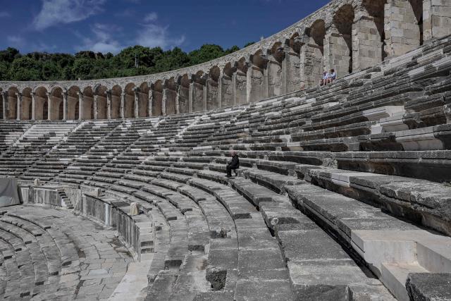 Tourists visit the ancient amphitheater of Aspendos, part of the ancient Greco-Roman city in Antalya province, in Antalya on May 4, 2026. (Photo by Adem ALTAN / AFP)