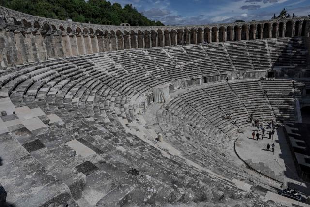 Tourists visit the ancient amphitheater of Aspendos, part of the ancient Greco-Roman city in Antalya province, in Antalya on May 4, 2026. (Photo by Adem ALTAN / AFP)