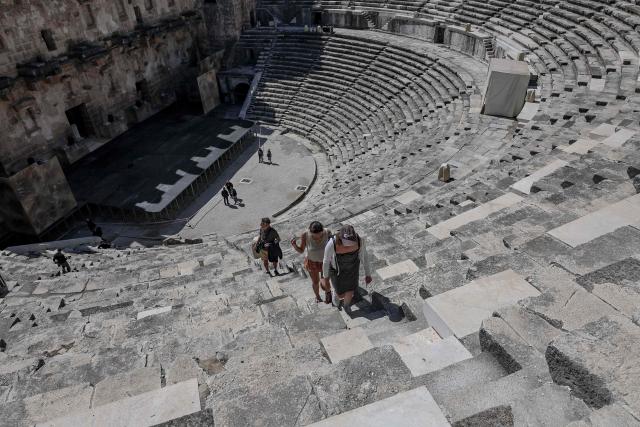 Tourists visit the ancient amphitheater of Aspendos, part of the ancient Greco-Roman city in Antalya province, in Antalya on May 4, 2026. (Photo by Adem ALTAN / AFP)