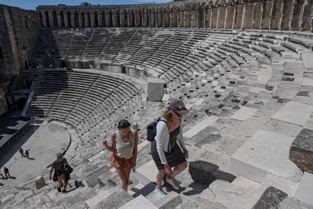 Tourists visit the ancient amphitheater of Aspendos, part of the ancient Greco-Roman city in Antalya province, in Antalya on May 4, 2026. (Photo by Adem ALTAN / AFP)