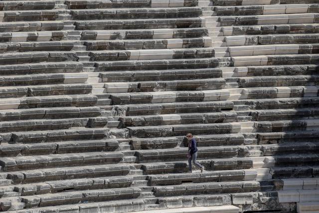 A tourist visits the ancient amphitheater of Aspendos, part of the ancient Greco-Roman city in Antalya province, in Antalya on May 4, 2026. (Photo by Adem ALTAN / AFP)