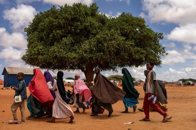 Displaced Somali school pupils head back after school hours at a camp for internally displaced persons (IDP) in the outskirts of Kismayo town, on April 21, 2026. Millions of people in Somalia are facing the repercussions of a severe drought after three consecutive failed raining seasons. Kismayo, the capital of Jubaland State in southern Somalia, is one of the largest IDP-receiving cities in the Horn of Africa country, receiving hundreds of thousands of people fleeing the prolonged drought and conflict. Save the Children provides health and nutrition services across the camp. (Photo by SIMON MAINA / AFP)