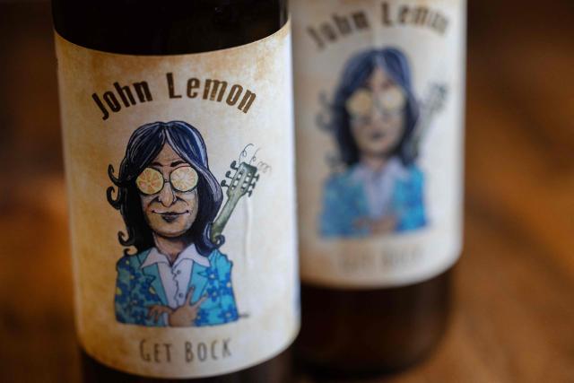 This photograph taken in Bannalec, western France on May 5, 2026 shows bottles of a beer named 'John Lemon', a play on words in reference to British musician John Lennon at the brewery 'Brasserie de l'imprimerie'. Following a formal notice from Yoko Ono, the widow of the Beatles singer, a Breton brewery has sold several thousand bottles of ‘John Lemon’ beer in just a few days – beer it will no longer be able to sell after July 1, 2026, the brewer told AFP on May 5, 2026. At the end of March, a Dutch law firm served the brewery with a formal notice to cease marketing ‘John Lemon’, failing which it would face having to pay substantial sums to the Yoko Ono Trust, which is responsible for protecting John Lennon’s image. (Photo by Fred TANNEAU / AFP)