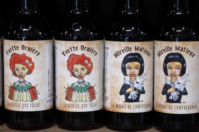 This photograph taken in Bannalec, western France on May 5, 2026 shows bottles of beers named 'Yvette Orniere' and 'Mireille Mafieux', play on words in reference to French accordionist and pianist Yvette Horner and French singer Mireille Mathieu displayed at the brewery 'Brasserie de l'imprimerie'. Following a formal notice from Yoko Ono, the widow of the Beatles singer, a Breton brewery has sold several thousand bottles of ‘John Lemon’ beer in just a few days – beer it will no longer be able to sell after July 1, 2026, the brewer told AFP on May 5, 2026. At the end of March, a Dutch law firm served the brewery with a formal notice to cease marketing ‘John Lemon’, failing which it would face having to pay substantial sums to the Yoko Ono Trust, which is responsible for protecting John Lennon’s image. (Photo by Fred TANNEAU / AFP)