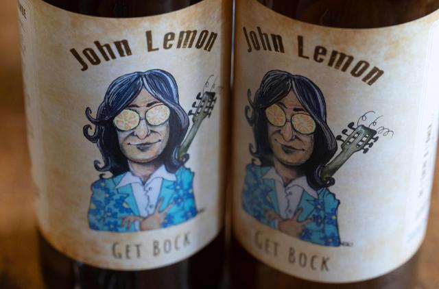 This photograph taken in Bannalec, western France on May 5, 2026 shows bottles of a beer named 'John Lemon', a play on words in reference to British musician John Lennon at the brewery 'Brasserie de l'imprimerie'. Following a formal notice from Yoko Ono, the widow of the Beatles singer, a Breton brewery has sold several thousand bottles of ‘John Lemon’ beer in just a few days – beer it will no longer be able to sell after July 1, 2026, the brewer told AFP on May 5, 2026. At the end of March, a Dutch law firm served the brewery with a formal notice to cease marketing ‘John Lemon’, failing which it would face having to pay substantial sums to the Yoko Ono Trust, which is responsible for protecting John Lennon’s image. (Photo by Fred TANNEAU / AFP)