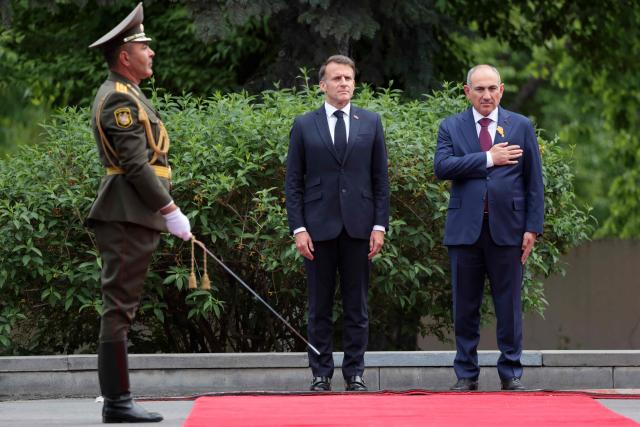 France's President Emmanuel Macron and Armenia's Prime Minister Nikol Pashinyan attend a welcoming ceremony prior to their talks in Yerevan on May 5, 2026. (Photo by Ludovic MARIN / AFP)
