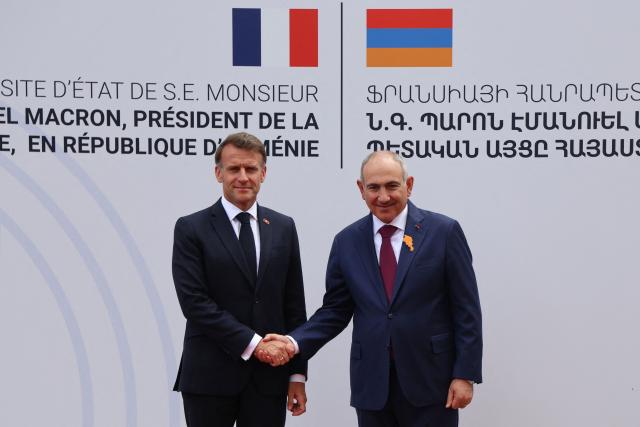 France's President Emmanuel Macron and Armenia's Prime Minister Nikol Pashinyan shake hands during a welcoming ceremony prior to their talks in Yerevan on May 5, 2026. (Photo by Ludovic MARIN / AFP)