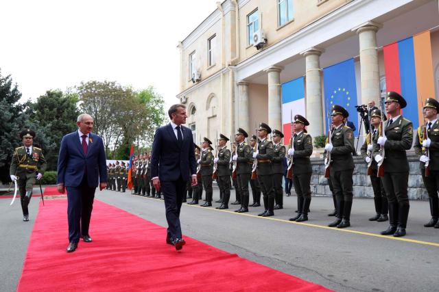 France's President Emmanuel Macron and Armenia's Prime Minister Nikol Pashinyan attend a welcoming ceremony prior to their talks in Yerevan on May 5, 2026. (Photo by Ludovic MARIN / AFP)