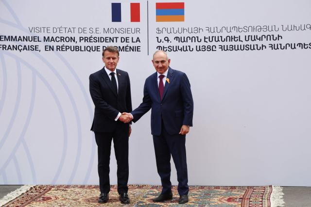 France's President Emmanuel Macron and Armenia's Prime Minister Nikol Pashinyan shake hands during a welcoming ceremony prior to their talks in Yerevan on May 5, 2026. (Photo by Ludovic MARIN / AFP)