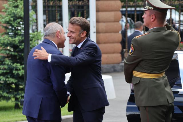 France's President Emmanuel Macron and Armenia's Prime Minister Nikol Pashinyan greet each other prior to their talks in Yerevan on May 5, 2026. (Photo by Ludovic MARIN / AFP)