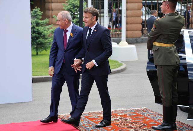 France's President Emmanuel Macron and Armenia's Prime Minister Nikol Pashinyan walk prior to their talks in Yerevan on May 5, 2026. (Photo by Ludovic MARIN / AFP)