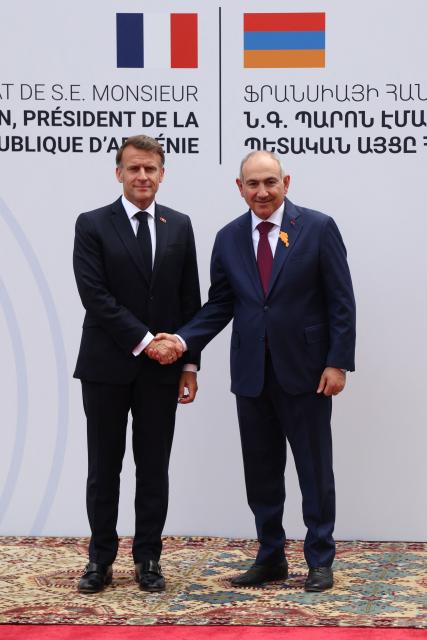 France's President Emmanuel Macron and Armenia's Prime Minister Nikol Pashinyan shake hands during a welcoming ceremony prior to their talks in Yerevan on May 5, 2026. (Photo by Ludovic MARIN / AFP)