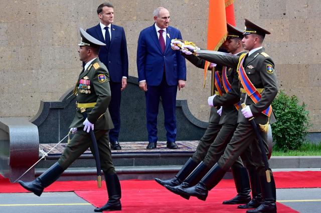 France's President Emmanuel Macron and Armenia's Prime Minister Nikol Pashinyan attend a welcoming ceremony prior to their talks in Yerevan on May 5, 2026. (Photo by KAREN MINASYAN / AFP)