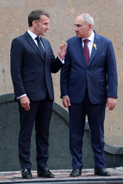 France's President Emmanuel Macron and Armenia's Prime Minister Nikol Pashinyan interact during a welcoming ceremony prior to their talks in Yerevan on May 5, 2026. (Photo by Ludovic MARIN / AFP)