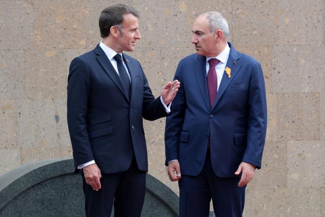France's President Emmanuel Macron and Armenia's Prime Minister Nikol Pashinyan interact during a welcoming ceremony prior to their talks in Yerevan on May 5, 2026. (Photo by Ludovic MARIN / AFP)