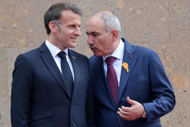 France's President Emmanuel Macron and Armenia's Prime Minister Nikol Pashinyan interact during a welcoming ceremony prior to their talks in Yerevan on May 5, 2026. (Photo by Ludovic MARIN / AFP)