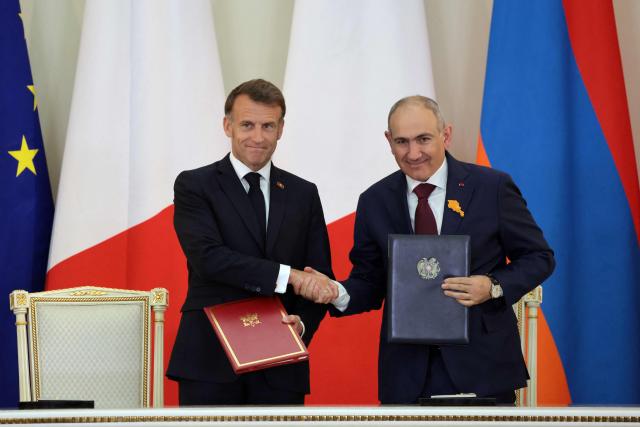 France's President Emmanuel Macron and Armenia's Prime Minister Nikol Pashinyan attend a ceremony to sign agreements during their talks in Yerevan on May 5, 2026. (Photo by Ludovic MARIN / AFP)