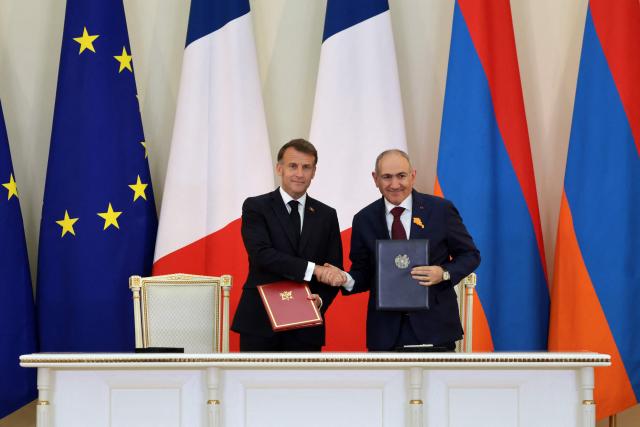 France's President Emmanuel Macron and Armenia's Prime Minister Nikol Pashinyan attend a ceremony to sign agreements during their talks in Yerevan on May 5, 2026. (Photo by Ludovic MARIN / AFP)