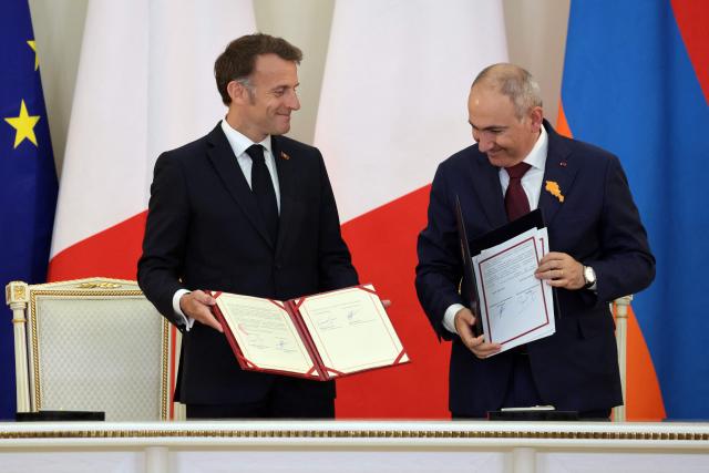 France's President Emmanuel Macron and Armenia's Prime Minister Nikol Pashinyan attend a ceremony to sign agreements during their talks in Yerevan on May 5, 2026. (Photo by Ludovic MARIN / AFP)