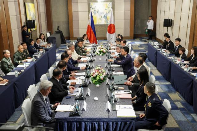 Japan's Defense Minister Shinjiro Koizumi (centre R) gestures to Philippines' Defense Secretary Gilbert Teodoro Jr. (centre L) during a bilateral meeting in Manila on May 5, 2026.  (Photo by MARK CRISTINO / AFP)