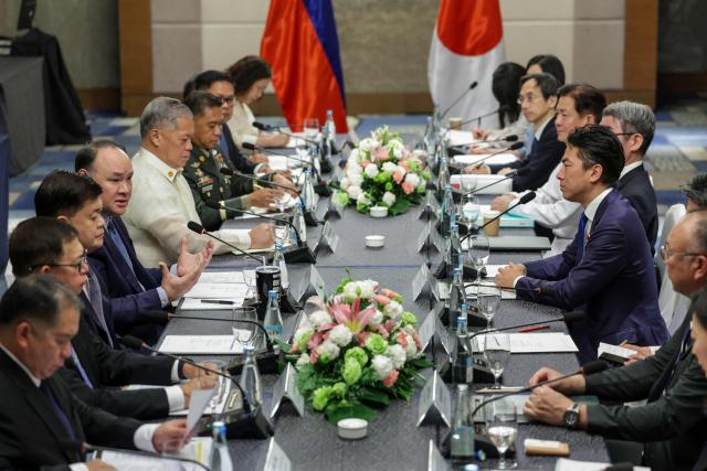 Japan's Defense Minister Shinjiro Koizumi (centre R) and Philippines' Defense Secretary Gilbert Teodoro Jr. (centre L) take part in a bilateral meeting in Manila on May 5, 2026.  (Photo by MARK CRISTINO / AFP)