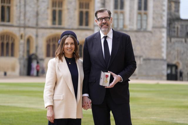 British author Richard Osman and his partner Ingrid Oliver (L) pose after he was made an OBE (Officer of the Order of the British Empire) following an investiture ceremony at Windsor Castle in Windsor on May 5, 2026. (Photo by Andrew Matthews / POOL / AFP)