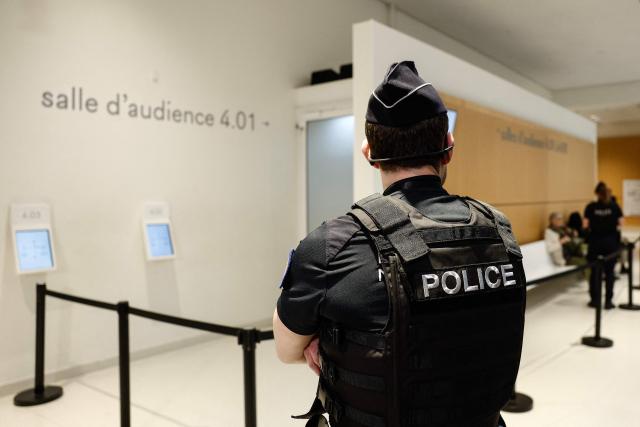 A French Police Nationale officer stands outside a courtroom ahead of the sexual assault trial against an after-school club leader at a primary school, at the Paris courthouse in Paris on May 5, 2026. (Photo by Kenzo TRIBOUILLARD / AFP)