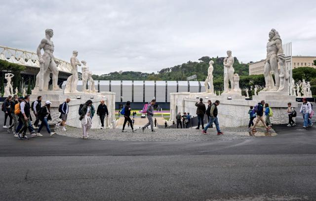 People walk near the "Super Tennis Arena" a temporary tennis court built inside the Marble Stadium (Stadio dei Marmi) for the ATP/WTA Tennis tournament of Rome, on May 5, 2026. (Photo by Tiziana FABI / AFP)